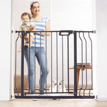 Black extra-tall baby gate with walk-through door and vertical metal bars