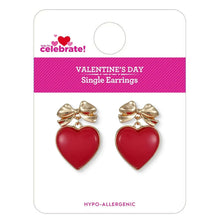 Red heart drop earrings with gold-tone bows, shown on retail card