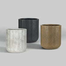 Three resin planters in light gray, dark gray, and tan with textured cylindrical bodies