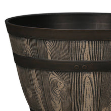 Whiskey barrel resin planter close-up with black rim and engraved wood-grain bands