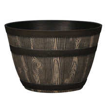 Whiskey barrel-style resin planter in dark brown with black rim and wood-grain texture