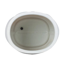 White resin planter base with oval drainage hole