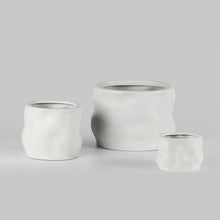 Three white resin planters in different sizes for flowers or succulents