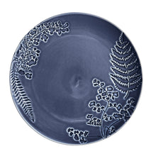 Blue stoneware dinner plate with raised floral and fern pattern around rim