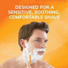 Man shaving with a disposable razor and shaving lather, orange handle visible