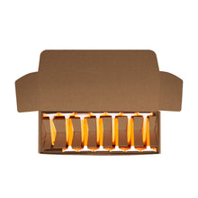 Open carton with multiple disposable razors, showing orange handles and white heads
