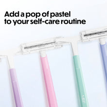Set of disposable razors with two blades, pastel handles.