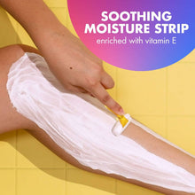 Women’s razor with pink handle and 3 metal blades in use on skin