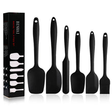Black silicone spatula set with hanging holes, including a small basting brush