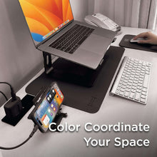 Black faux leather desk mat with phone and keyboard accessories on top