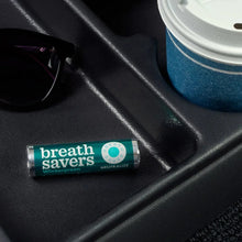 Wintergreen sugar-free breath mint roll with turquoise label on dark surface