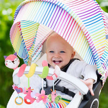 Baby in stroller seat with hanging owl and pastel plush rattles toy