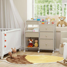 Baby changing storage cart with fabric top bins and three stacked drawers on casters.