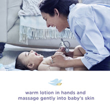 Caregiver massaging warm lotion onto baby’s skin