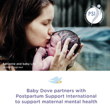 Parent holding and kissing baby while applying bedtime lotion for soothing care