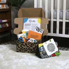 Toy gift set in open box with fabric cloth books and learning cards
