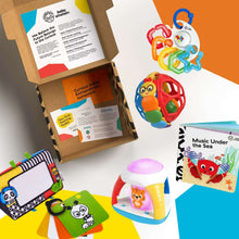 Open toy gift box with colorful play ball, learning booklets, and soft cards