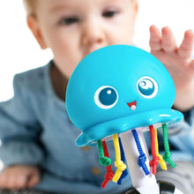 Blue whale music teacher toy with face eyes and hanging colorful sound ribbons