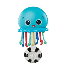 Blue whale music teacher toy with smiling face and hanging colorful ribbon strings