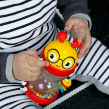 Baby activity rattle with yellow face, red top, and clear shaker chamber