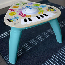 Teal-legged electronic music activity table with colorful piano keyboard top