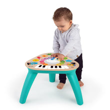 Wooden toddler music activity table with teal legs and colorful piano keyboard top