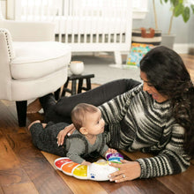 Baby Einstein light bar activity station on floor as baby presses colorful buttons
