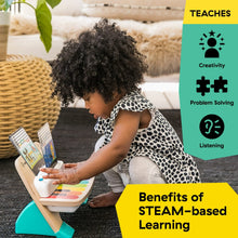 Baby sitting and playing wooden touch piano toy with screen