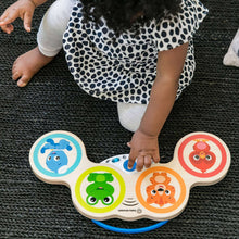 Wooden touch drum toy with three animal face panels and child hand pressing keys