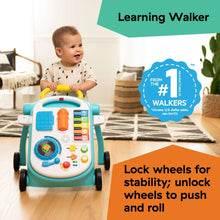 Toddler with blue musical push walker featuring an activity panel
