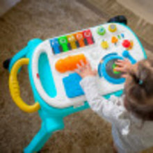 Blue and white musical activity walker with raised play panel and spinning dial