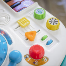 White activity panel with colorful buttons and dials on a blue push walker