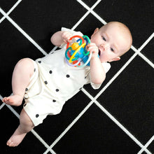 Baby holding blue ocean teether and rattle toy with multicolor ring beads
