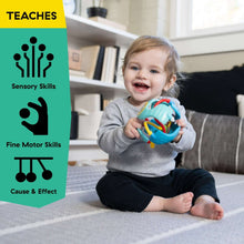 Sitting baby playing with teal sensory rattle ball with colorful textured wires