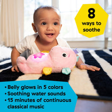 Pink seahorse plush soother with glowing belly and multicolor sensory tags