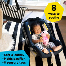 Pink seahorse plush soother with glowing belly for soothing in a baby seat