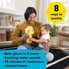 Yellow seahorse plush soother in hands, teal fins and glowing orange star pad
