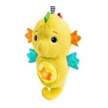 Yellow seahorse plush soother with star, teal fins and a striped fabric tag