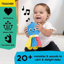 Baby holding a blue plush take-along soother with crinkle and soft sensory textures