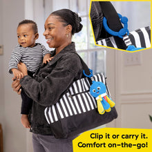 Baby and adult holding a blue plush take-along soother with clip for portability