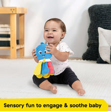 Blue plush take-along soother toy in baby’s hands on the floor