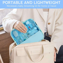 Portable blue baby grooming kit zip case held open in adult hand