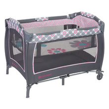 Gray baby playard with floral polka-dot trim and see-through mesh panels