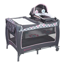 Gray baby playard with bassinet, floral dot trim, and mesh side panels