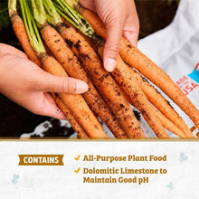 Hands holding carrot seedlings in dark soil with a garden soil bag in view