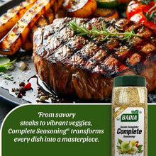 Seasoning bottle with green cap beside grilled steak with herb garnish and roasted vegetables.