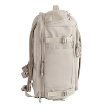 Beige backpack with front storage panels, zip pockets, and adjustable side straps