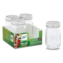 Clear glass mini mason jars with silver lids in a 4-pack carton