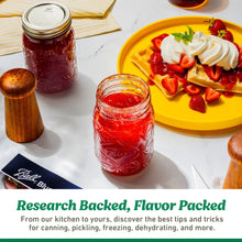 Wide-mouth mason jars with metal lids and rings, filled preserves on a kitchen counter