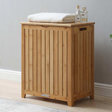 Bamboo laundry hamper with slatted front, removable lid, and folded white liner on top